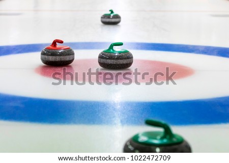 curling stones on the ice Royalty-Free Stock Photo #1022472709