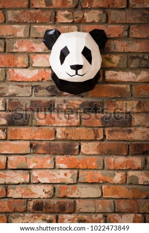 Red brick wall with the figure of a Panda bear