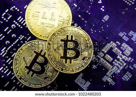 Cryptocurrency Bitcoin On The Motherboard. Gold Coin. Virtual Currency.
