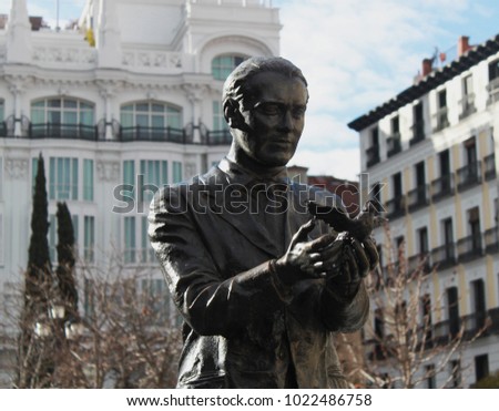 Statue of the famous poet, Federico García Lorca with a pigeon on Saint Anne Square (Plaza de Santa Ana) in Madrid, Spain, Europe. Old town neighborhood in the true inner city of Madrid. Royalty-Free Stock Photo #1022486758