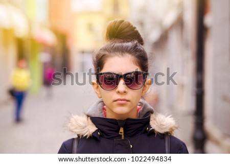A girl posing on a narrow street