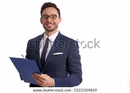 Handsome bearded businessman in office suit and tie isolated on white background. Professional bank manager is holding a blank clipboard Royalty-Free Stock Photo #1022504869