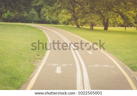 bicycle path along the park/bicycle path along the park in sunny day