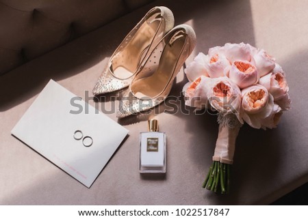 wedding. bride's shoes, perfume and wedding bouquet on the table Royalty-Free Stock Photo #1022517847