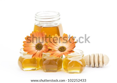 honey and flowers on white