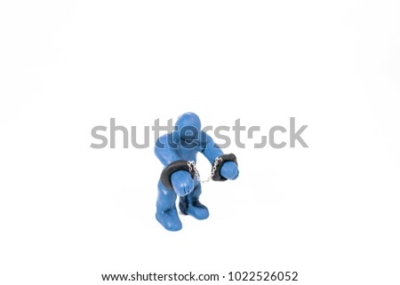 Abstract photo of guilty person in handcuffs. Made from Play Clay. Isolated on white background.