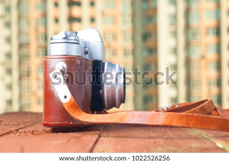 vintage camera on table with city view. Copy space