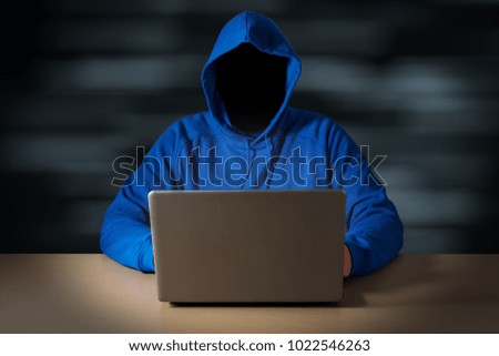 Computer hacker steals data from laptop. Theft of personal data and computer crimes