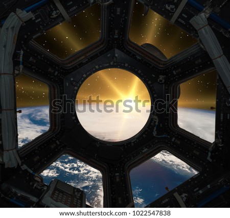 Fascinating sunrise on earth. Spaceship window view. Elements of this image furnished by NASA.
