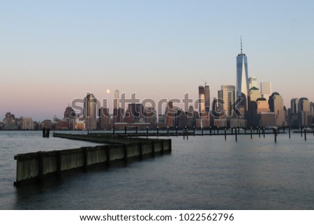 New York City downtown during a sunset from across the Hudson river