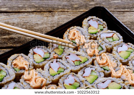 close up of sashimi sushi set with chopsticks and soy - sushi roll with salmon and sushi roll with smoked eel,