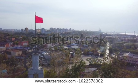 Top view of the small town with traffic on the road. Clip. Rush hour, city traffic in the city during the day