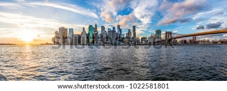 Panoramic Panorama view of outside outdoors in NYC New York City Brooklyn Bridge Park by east river, cityscape skyline during sunset