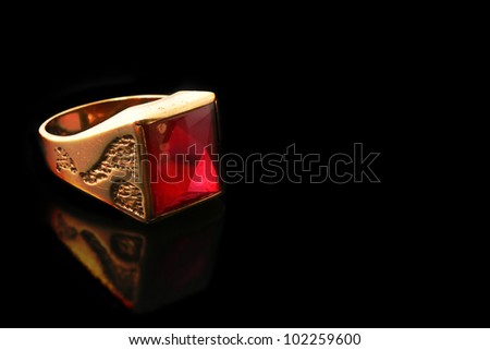Gold ring with red stones (ruby) with reflection