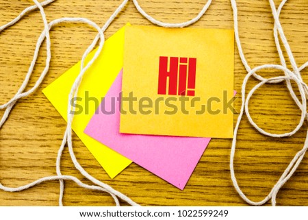 Hi word on yellow sticky note in wooden background. Bussines concept. Motivational.