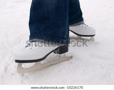 Woman's legs in skates and jeans