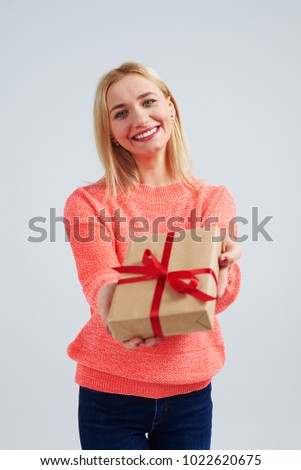 young blond smiling and holding gift