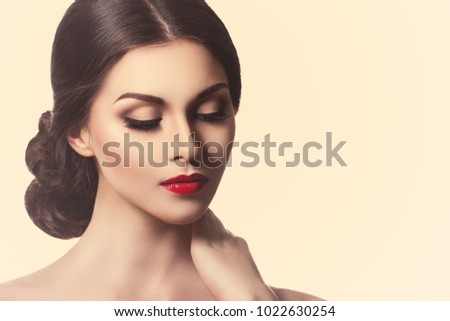 Portrait of a beautiful young woman in retro style. Ideal beauty. Red lips. Professional make-up. Photos of cosmetic advertising and care products for skin