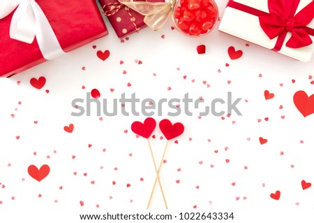 Gift boxes, candies and red heart shapes on white paper - Valentine's day, wedding and love background concept