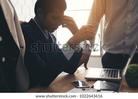 Businessman feel sad worry tired frustrated upset fail after lost work job from office . he become unhappy and depressed person But a colleague cheering alongside.