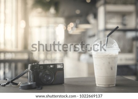 Closeup vintage film camera with coffee in cafe