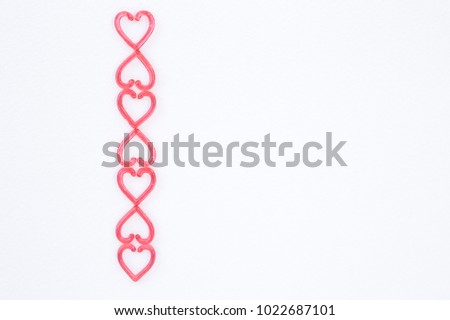 Mini red heart on white paper texture background, valentine concept background