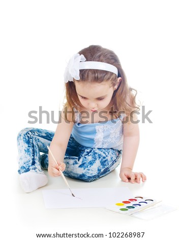 Cute girl drawling with watercolor paint and brush
