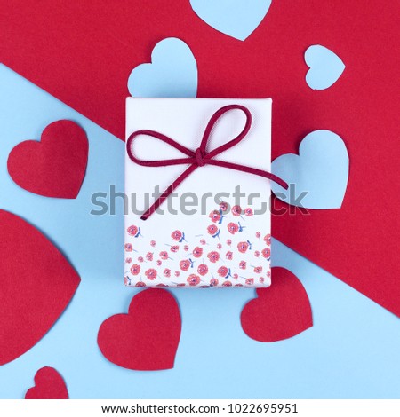 Gift or present box with ribbon and glitter heart dual colored background for Valentines day