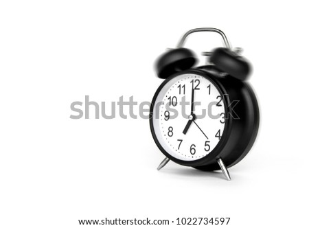 Black Alarm Clock bell classic vintage style running at alarm. To wake up is Life beginning of the day After sleep at time 7:00 a.m. Front a 45 degree angle. Isolated on white background.