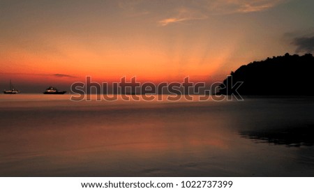 silhouette sunset at sea on beach
