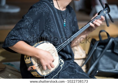 japanese woman playing traditional music instrument Royalty-Free Stock Photo #1022738173