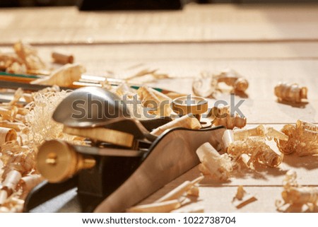 
DIY concept. Woodworking and crafts tools. Carpentry hand tools on a workbench. Planers, chisels, measuring tools.  Wooden parts, planks and stocks. Wooden background.