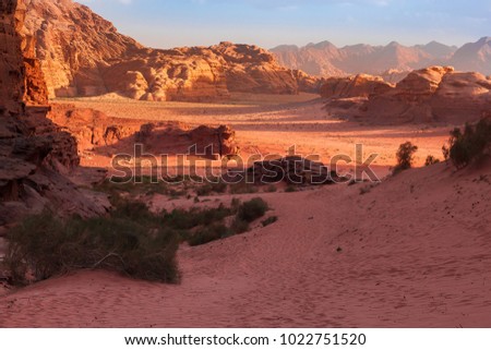 Red mountains of the canyon of Wadi Rum desert in Jordan. Wadi Rum also known as The Valley of the Moon is a valley cut into the sandstone and granite rock in southern Jordan to the east of Aqaba. Royalty-Free Stock Photo #1022751520