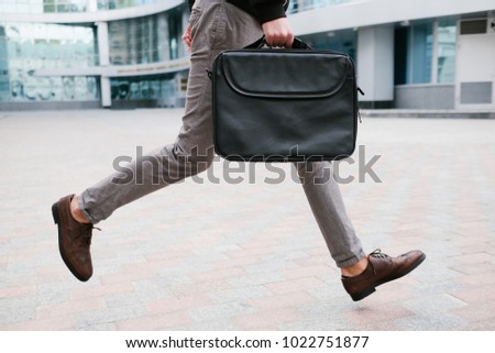 businessman rush lifestyle. man running late for work or meeting holding briefcase Royalty-Free Stock Photo #1022751877