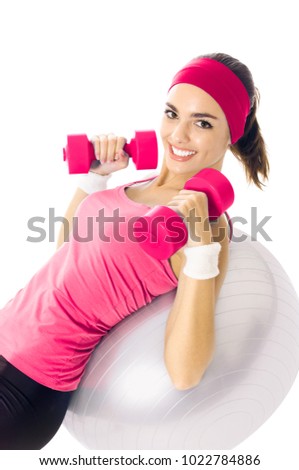 Young happy woman in red sportswear doing fitness exercise, isolated on white