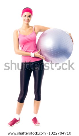 Young happy woman in red sportswear with fitness ball, isolated on white