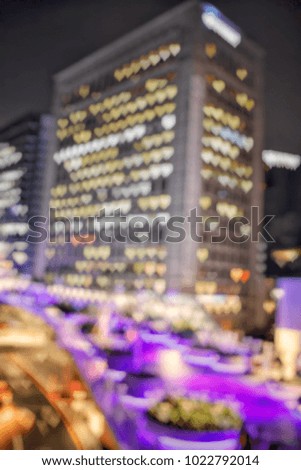 Blurred defocused background image of building on the night time with heart shape bokeh from lighting 