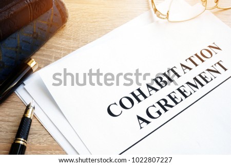 Cohabitation Agreement and books on a table. Royalty-Free Stock Photo #1022807227