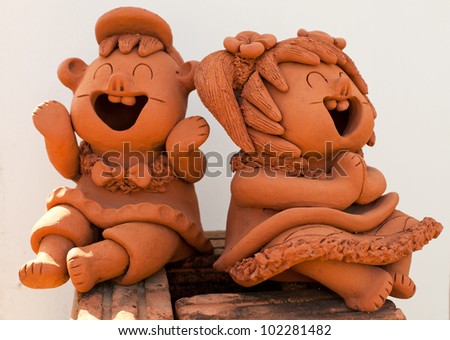two statuettes of funny boy and a girl