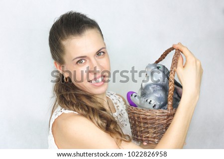 Easter. A beautiful girl with an Easter bunny in a basket and Easter eggs. Easter theme. on a white background