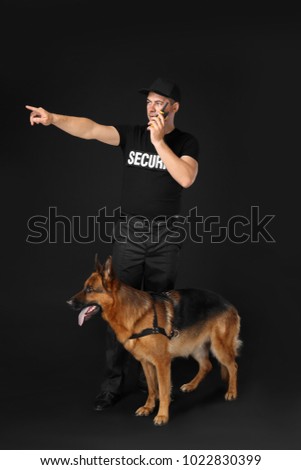 Security guard with dog on black background