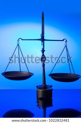 Law antique scales on blue futuristic background