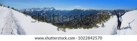 young woman make a selfie on hiking trail at the mountain top of wank, garmisch area, upper bavaria in winter