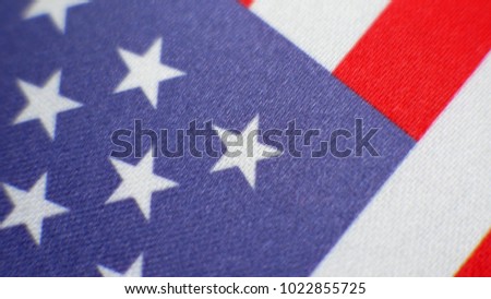 Red, blue and white American flag with the stars are turning