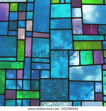 Image of a multicolored stained glass window with irregular block pattern in a hue of blue, square format Royalty-Free Stock Photo #102286066