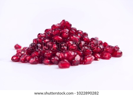 A pile of red pomegranate seeds