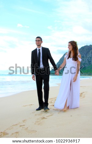 shooting wedding picture at the beach blue sky and clouds at he back view 