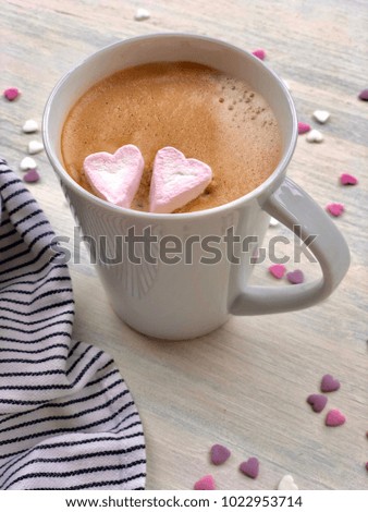 Two Marshmallow Hearts on Coffee Cup on Wooden Table Kitchen Towel and Many Sweet Hearts Love Valentine Day Theme