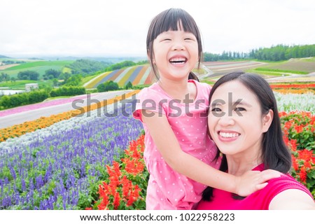 mother and daughter selfie and smile happily with beautiful landscape in Shikisai-no-oka