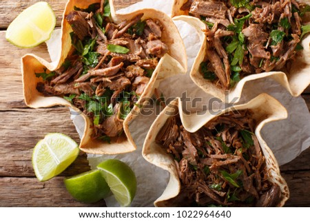 Mexican barbacoa tacos with spicy pulled beef close-up on the table. horizontal top view from above
